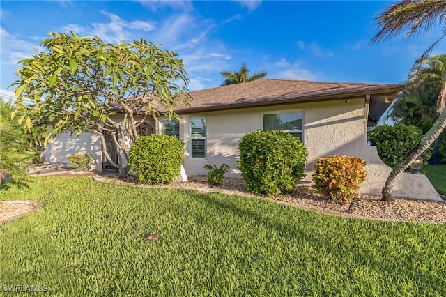 view of side of home featuring a lawn and a garage