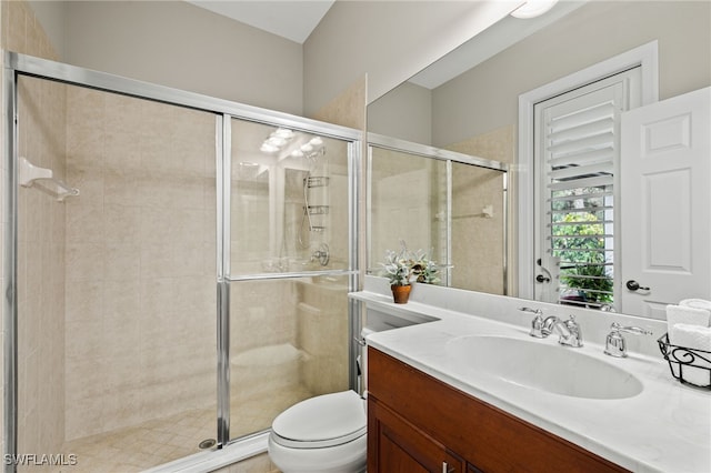 bathroom with vanity, walk in shower, and toilet