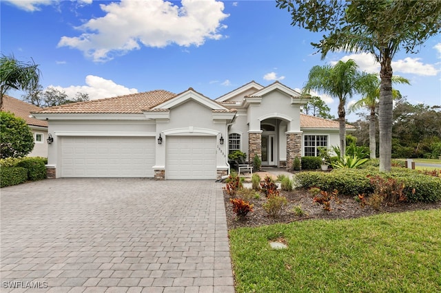 view of front of property with a front lawn and a garage