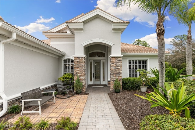 view of exterior entry featuring a patio