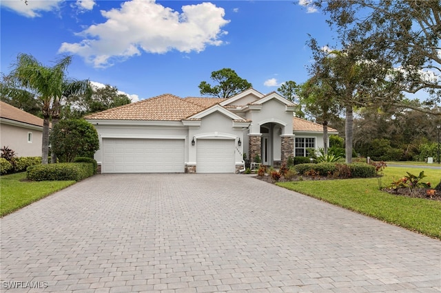 mediterranean / spanish house featuring a front yard and a garage