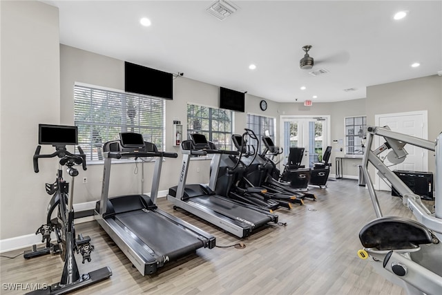 workout area with light hardwood / wood-style flooring and ceiling fan