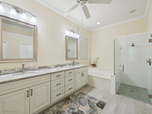 bathroom with hardwood / wood-style floors, separate shower and tub, and ornamental molding