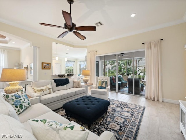 living room featuring light hardwood / wood-style floors, ornate columns, ceiling fan, and crown molding