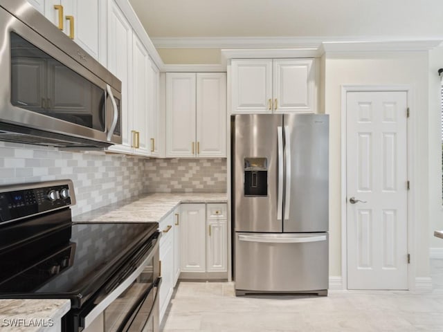 kitchen with light stone countertops, appliances with stainless steel finishes, tasteful backsplash, and white cabinetry