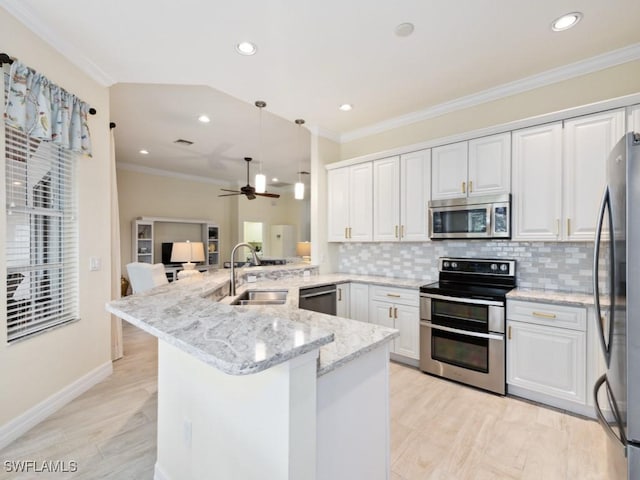 kitchen featuring kitchen peninsula, white cabinetry, sink, and stainless steel appliances