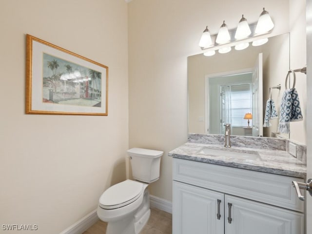 bathroom featuring tile patterned floors, vanity, and toilet