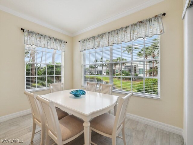 dining area with light hardwood / wood-style floors and crown molding