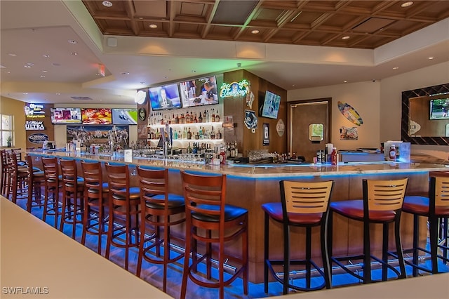 bar featuring coffered ceiling, indoor wet bar, and recessed lighting