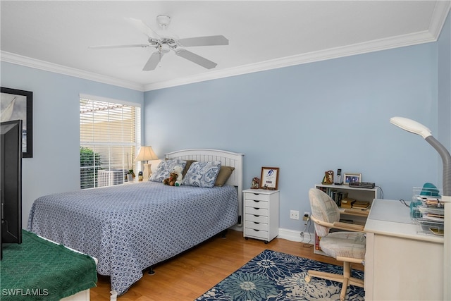 bedroom featuring ceiling fan, baseboards, wood finished floors, and crown molding