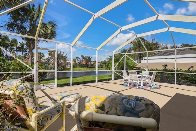 view of patio / terrace featuring glass enclosure and outdoor dining space