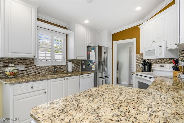 kitchen with white cabinetry, light stone countertops, white appliances, and ornamental molding