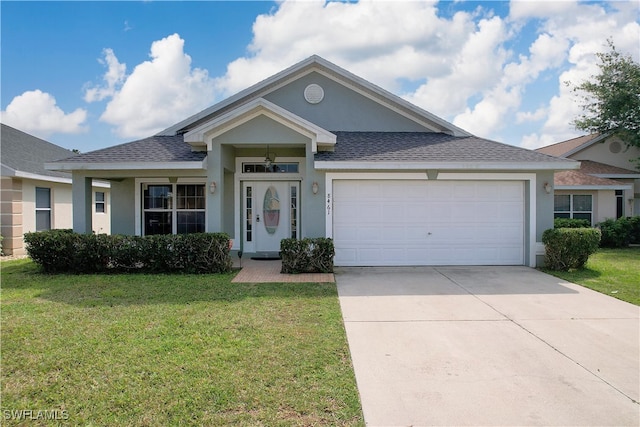 view of front of home with a front yard and a garage