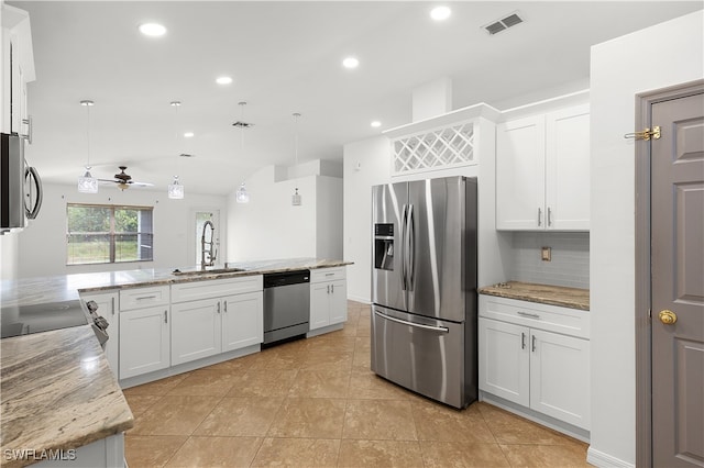 kitchen with sink, white cabinetry, stainless steel appliances, decorative light fixtures, and light stone counters