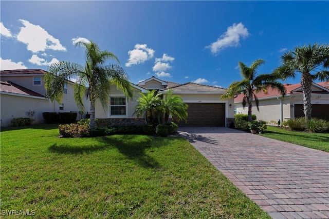 view of front facade with a garage and a front lawn