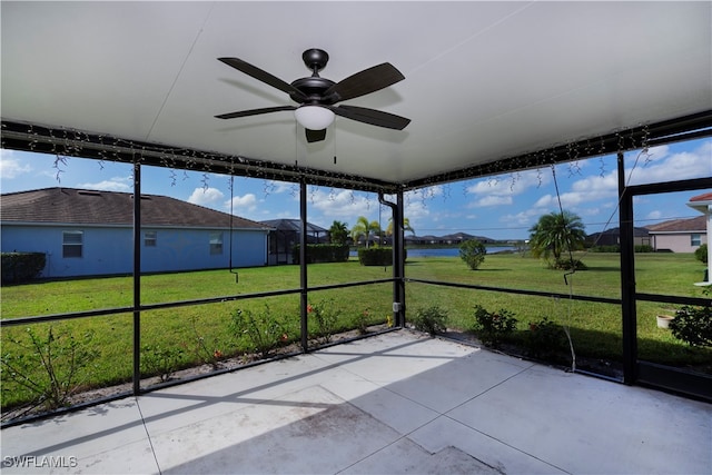 unfurnished sunroom with ceiling fan