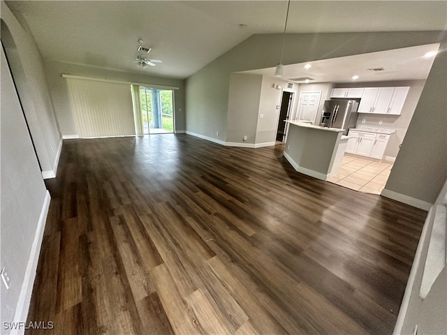 unfurnished living room featuring lofted ceiling, ceiling fan, and hardwood / wood-style flooring