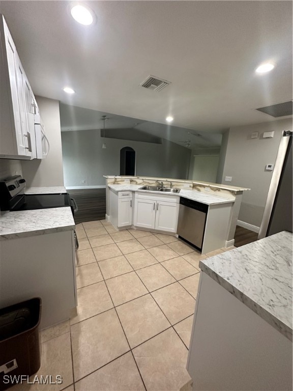 kitchen with light tile patterned floors, sink, range, white cabinetry, and dishwasher