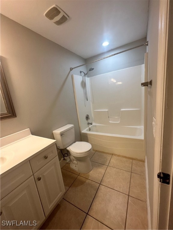 full bathroom featuring tile patterned flooring, shower / bath combination, vanity, and toilet