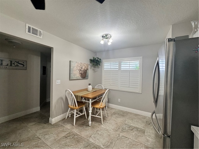 dining room with a textured ceiling