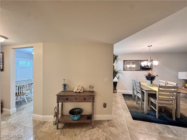 dining space with an inviting chandelier