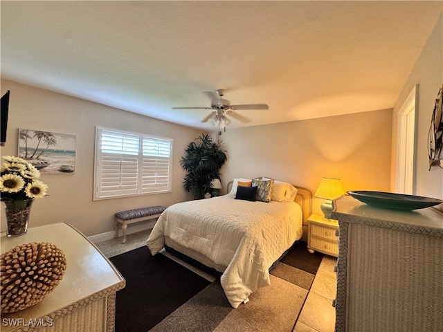 tiled bedroom featuring ceiling fan