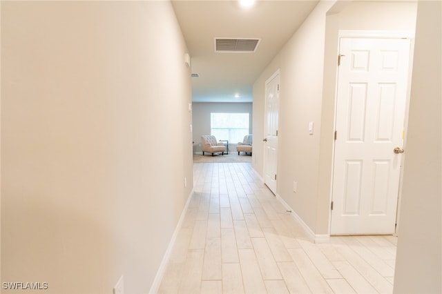 corridor featuring light hardwood / wood-style floors