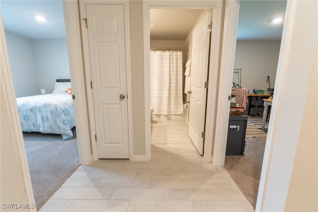 corridor with light colored carpet