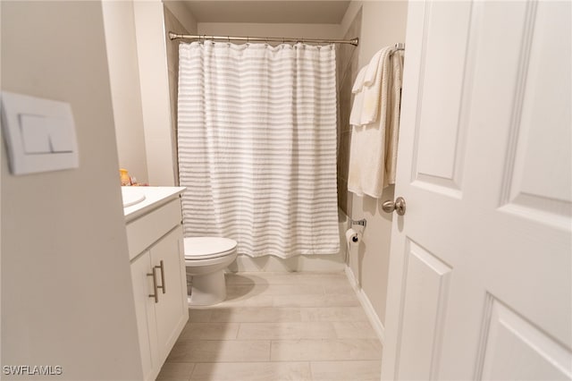 full bathroom featuring tile patterned flooring, vanity, shower / bath combo with shower curtain, and toilet