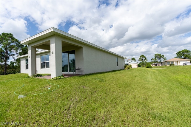 back of house featuring a yard