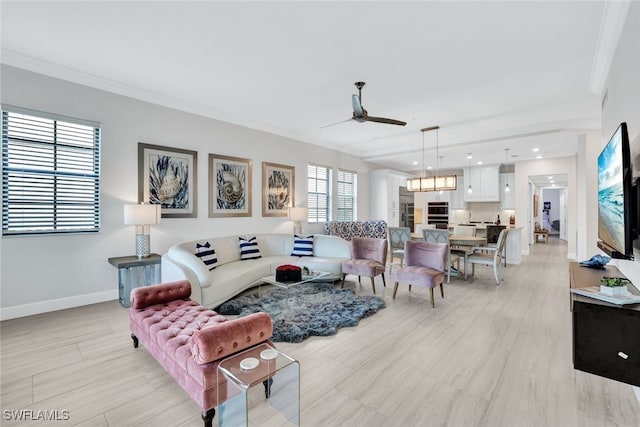 living room with ceiling fan and crown molding