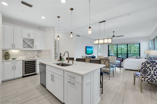 kitchen with white cabinets, wine cooler, ceiling fan, and sink