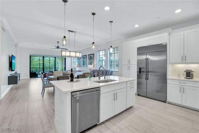 kitchen featuring white cabinetry, a kitchen island with sink, sink, and stainless steel appliances