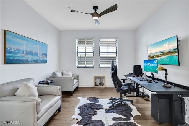 home office featuring hardwood / wood-style floors and ceiling fan