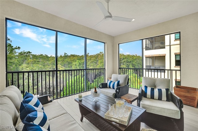 sunroom featuring ceiling fan