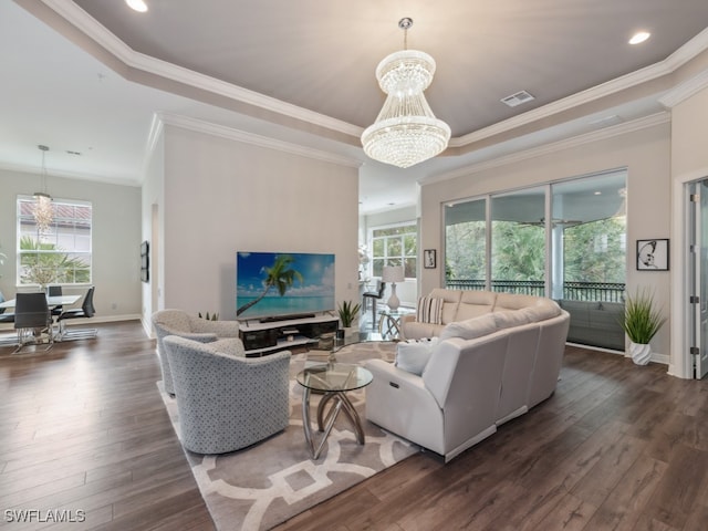 living room featuring dark wood-type flooring, crown molding, and plenty of natural light