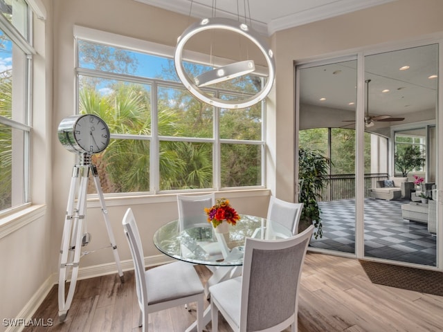 sunroom featuring ceiling fan