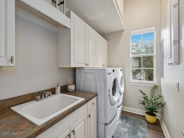 clothes washing area featuring cabinets, independent washer and dryer, sink, and dark wood-type flooring