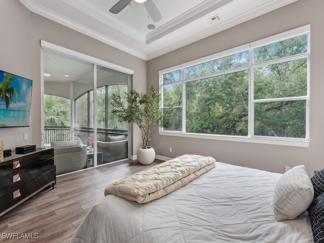 bedroom with hardwood / wood-style floors, crown molding, and ceiling fan