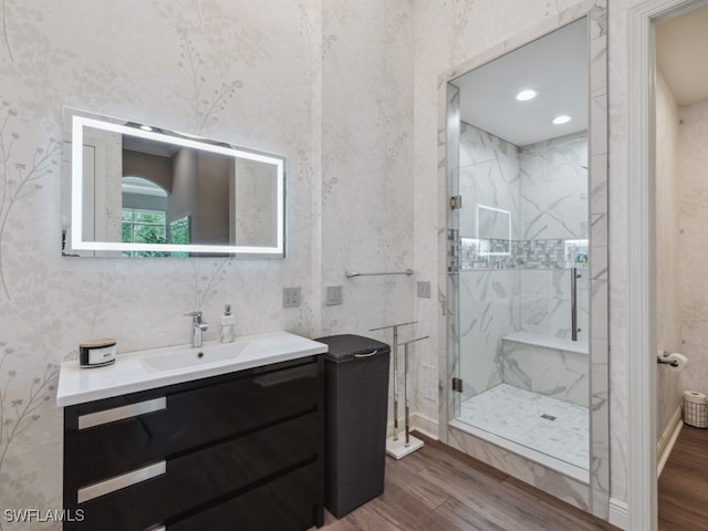 bathroom featuring vanity, hardwood / wood-style flooring, and a shower with door