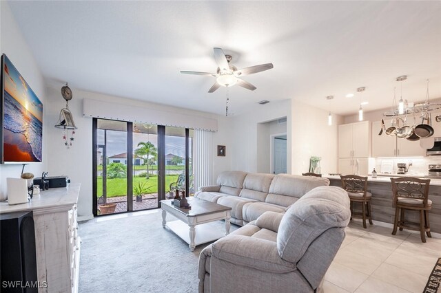 tiled living room with ceiling fan