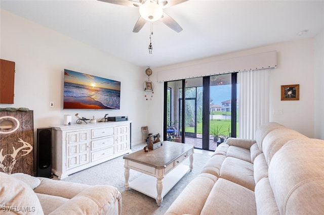 carpeted living room with ceiling fan