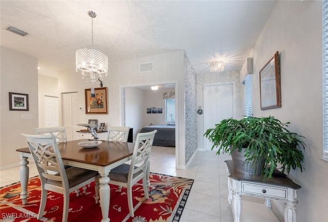 tiled dining area featuring an inviting chandelier