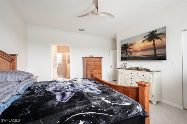 bedroom with light tile patterned floors, ensuite bath, and ceiling fan