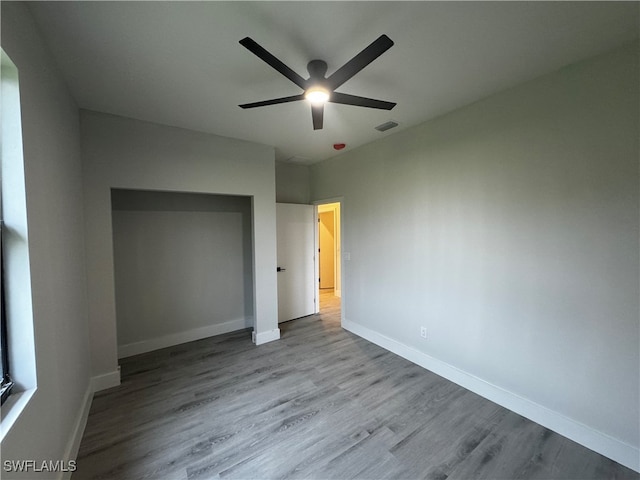 unfurnished bedroom with light hardwood / wood-style floors and ceiling fan