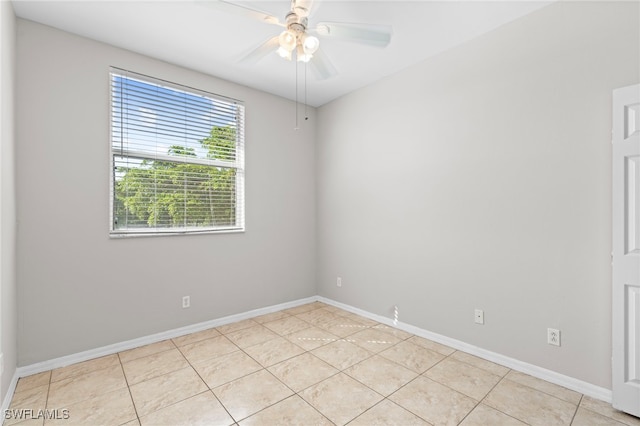 tiled empty room with ceiling fan