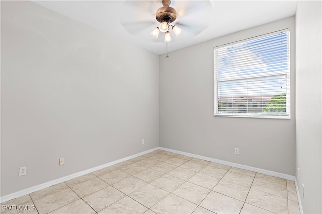 tiled empty room featuring ceiling fan