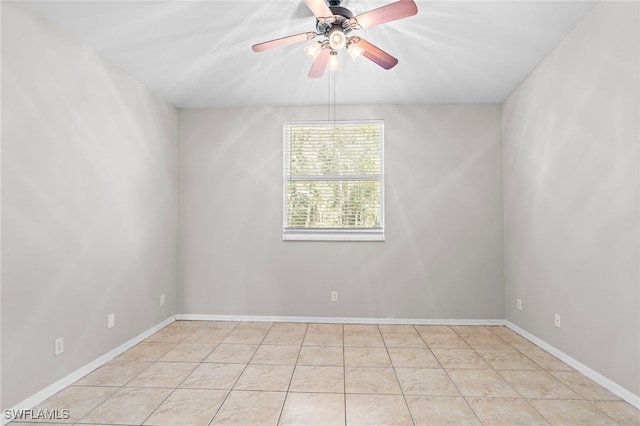 empty room with light tile patterned floors and ceiling fan