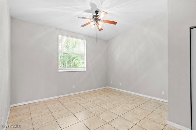 spare room with light tile patterned floors and ceiling fan