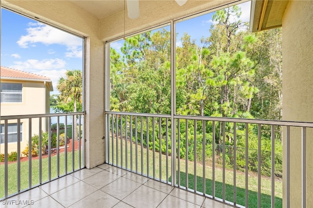 unfurnished sunroom featuring ceiling fan